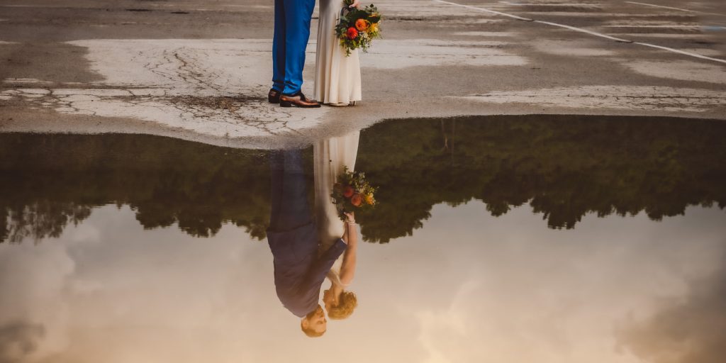 bride groom reflection in puddle