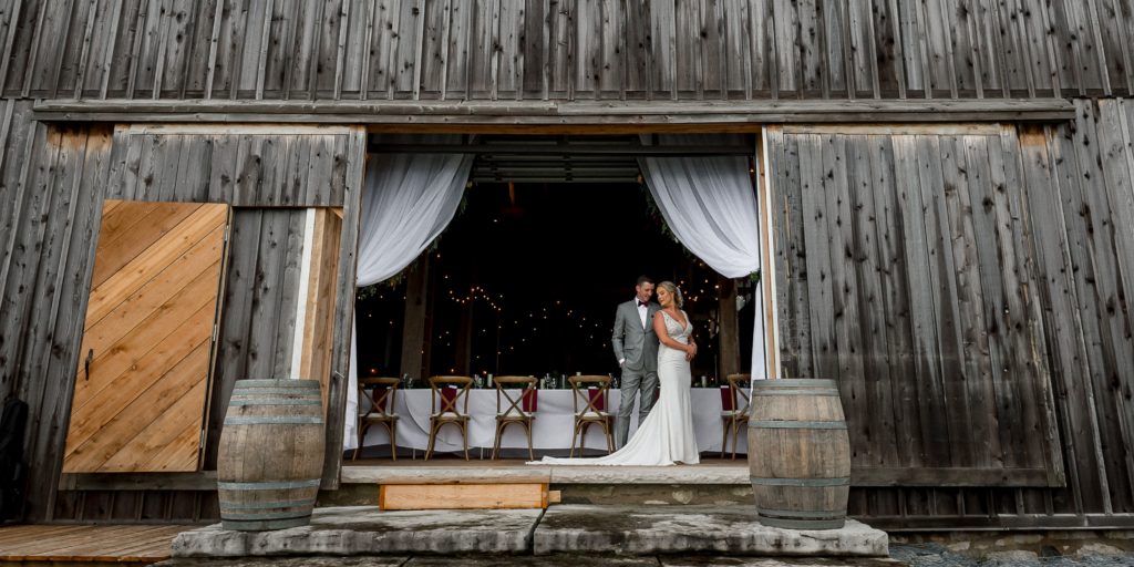 wedding portrait in door of grey barn