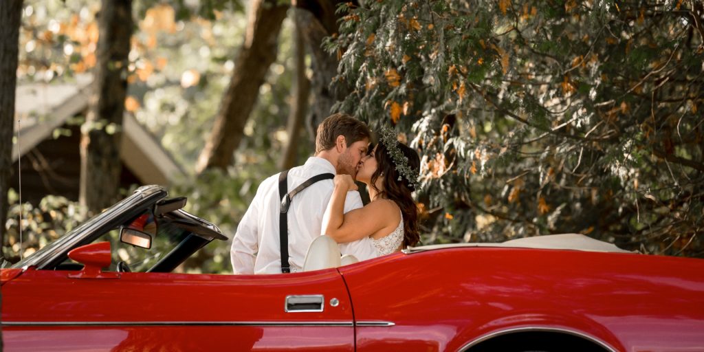 bride groom portrait with red convertible