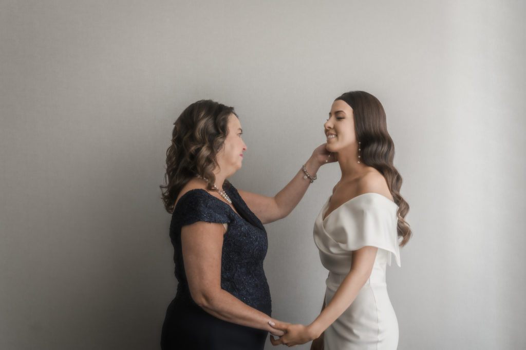 mom caressing daughters cheek