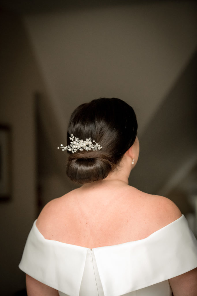 low bun with modern twist style for bride