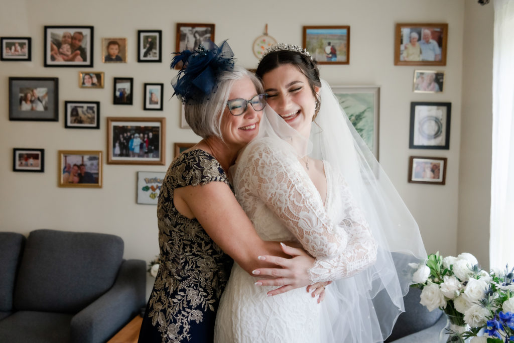 mom hugging daughter on wedding day