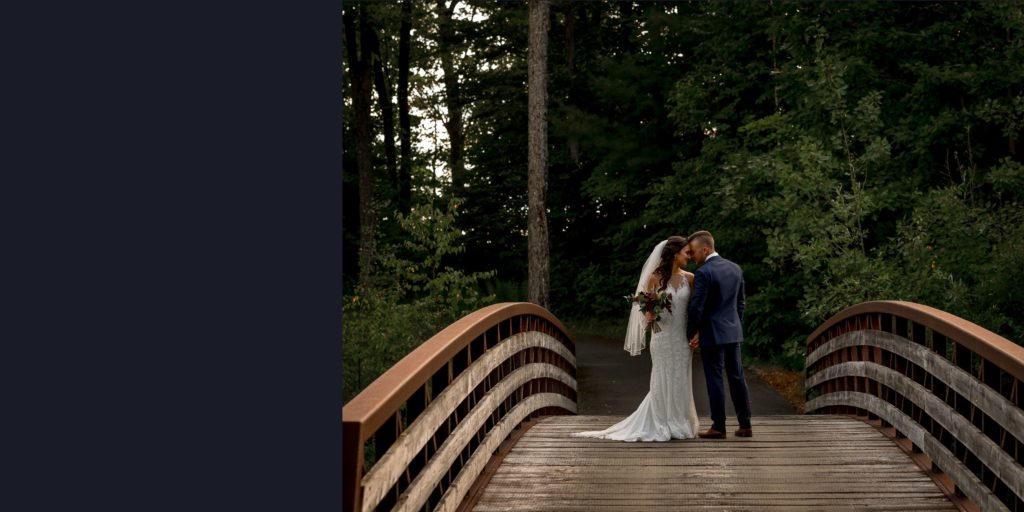 wedding couple on bridge with photographer