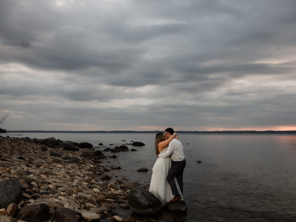 bride in strapless gown in water with groom