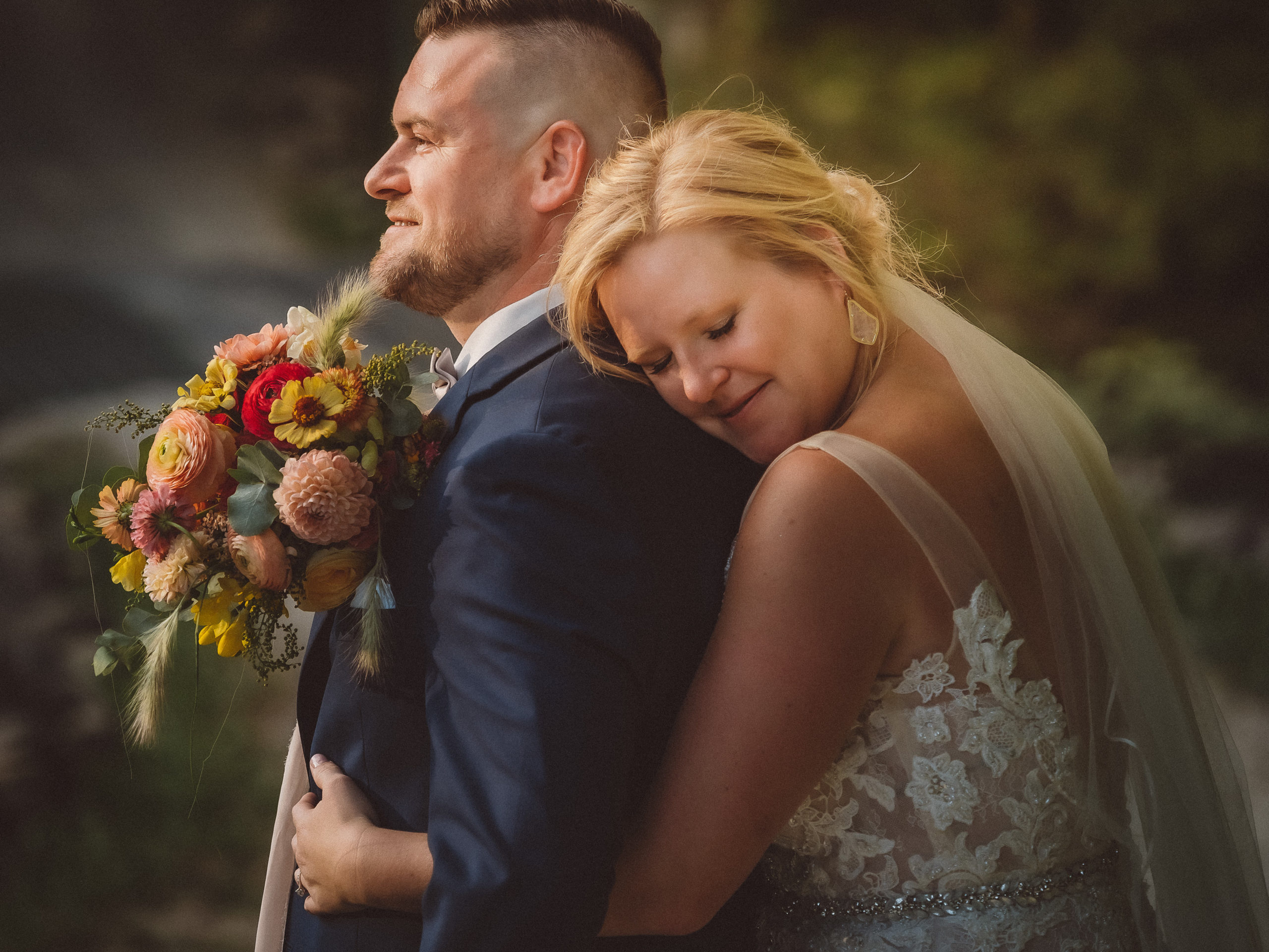 bride laying her head on grooms back