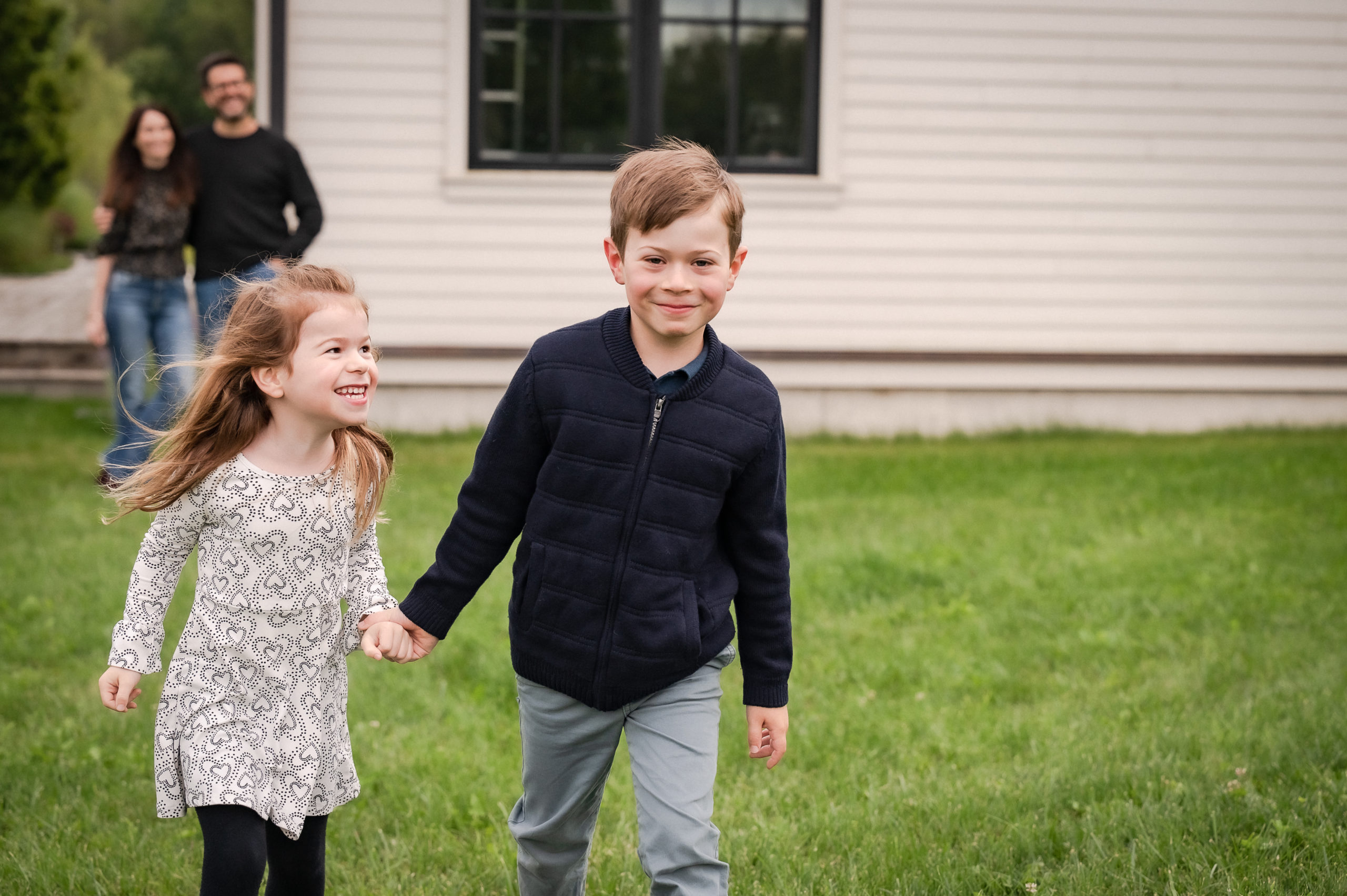 kids running while parents in background photos