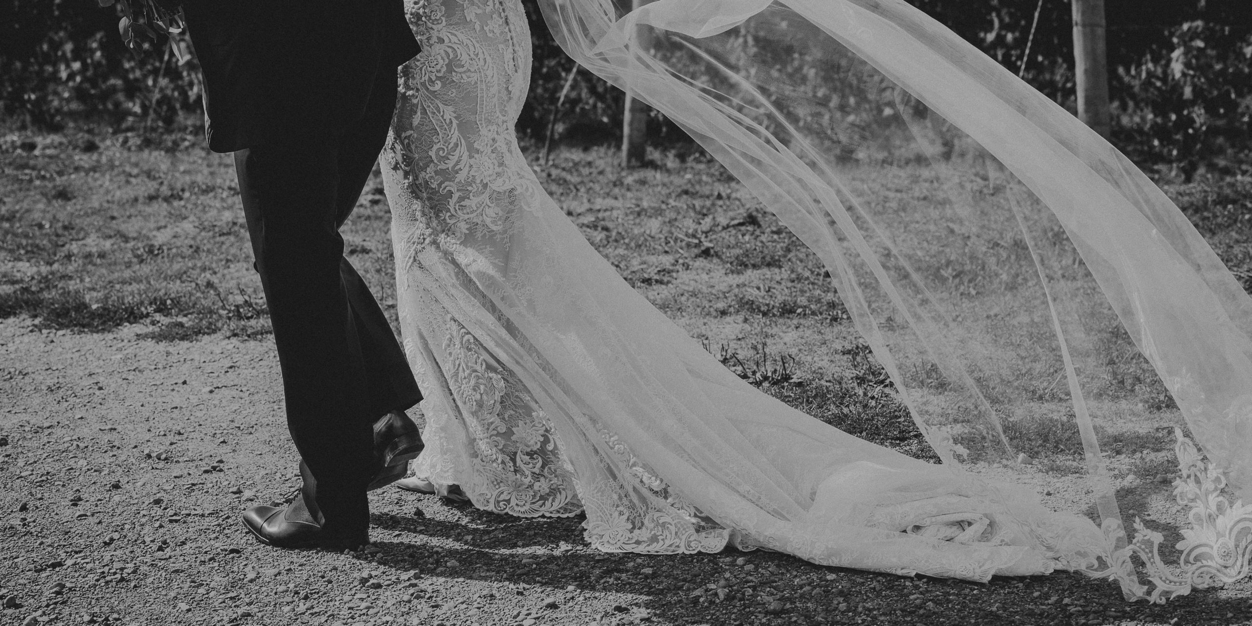 bride groom photo of them walking with veil