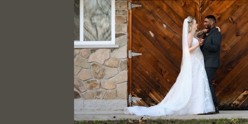 bride groom portrait in front of barn door