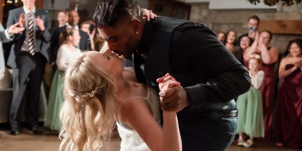 groom dips bride during first dance at Cambridge Mill