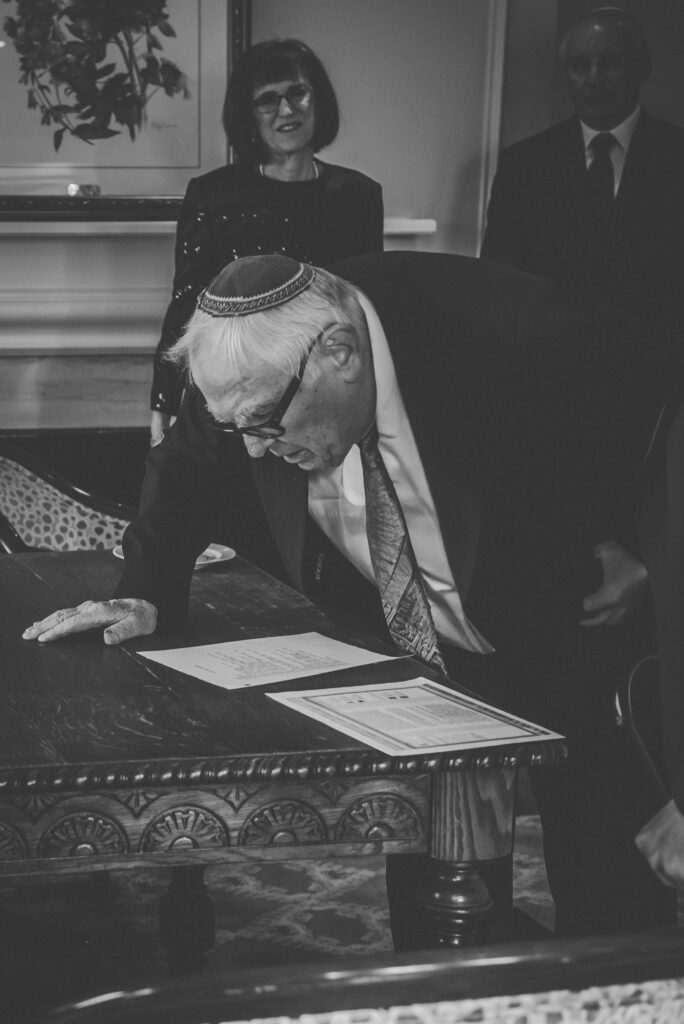 rabi looks over the details of the ketubah