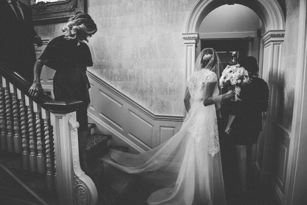 bride enters ceremony space with parents 
