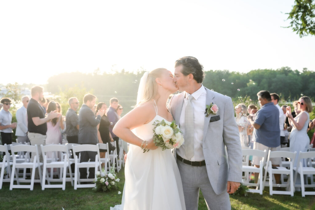 kissing photo during ceremony exit at Muskoka wedding