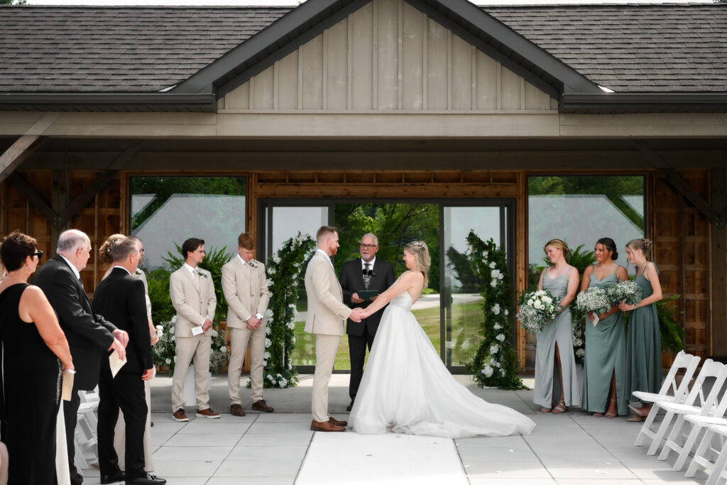 bride giggles during wedding ceremony at Shelburne Golf Club