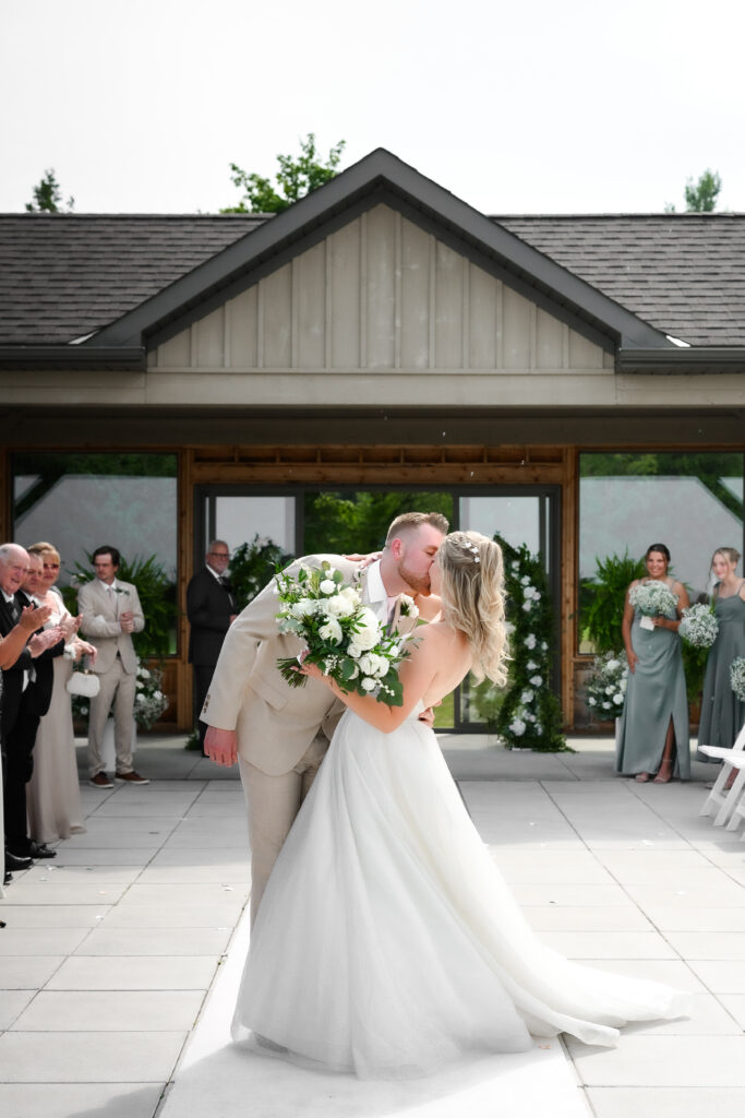 kiss during ceremony exit photo at golf club wedding