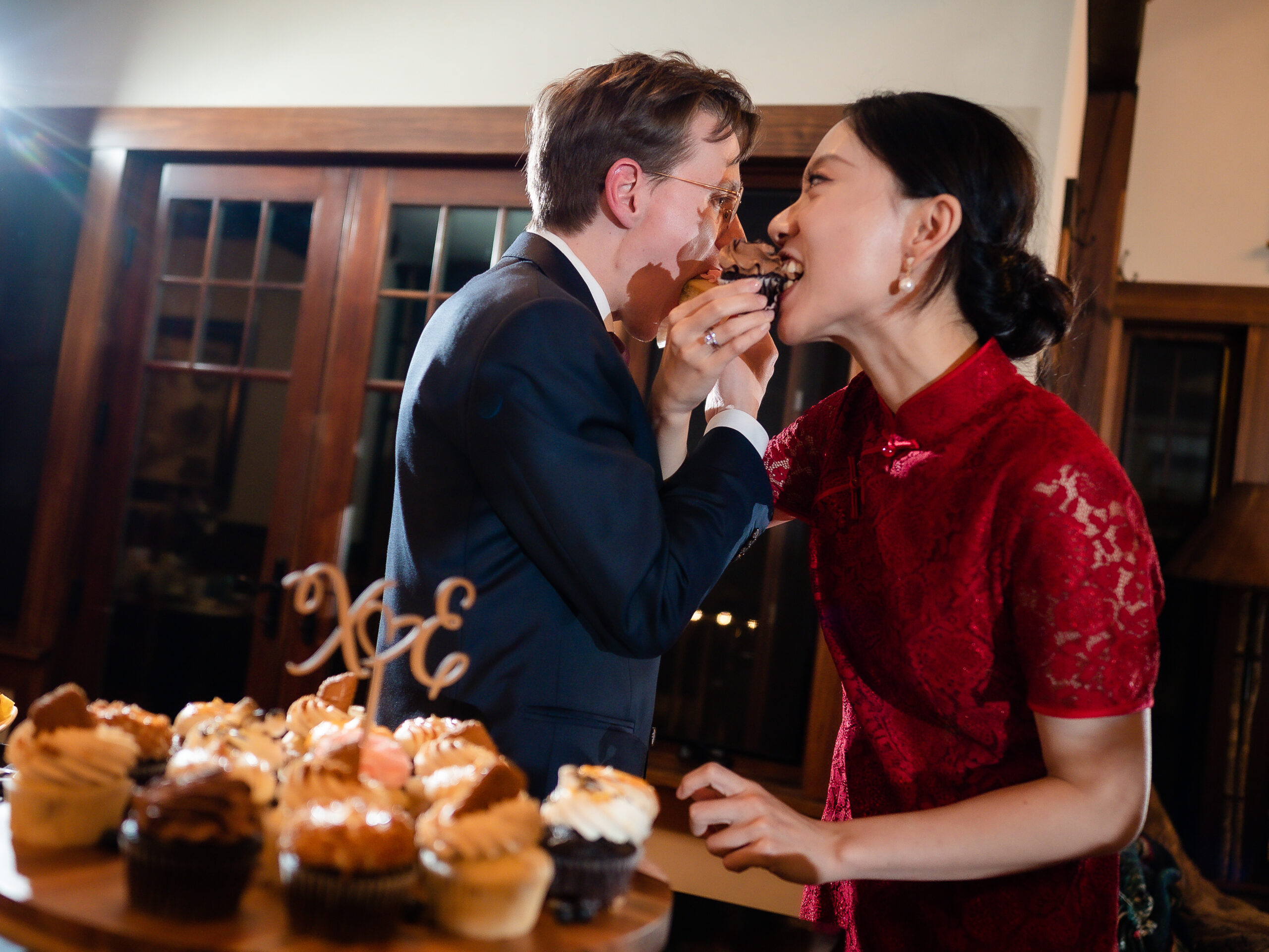 bride groom share cupcake at reception