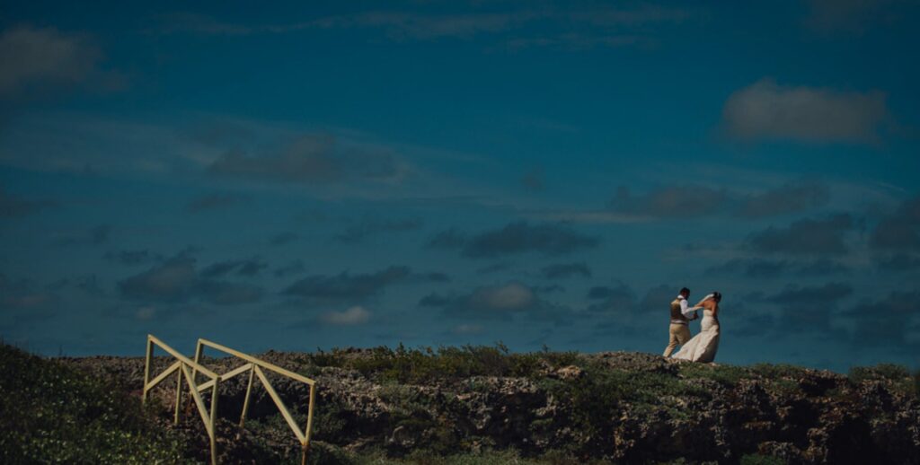 bride groom walk along cliff in Cuba