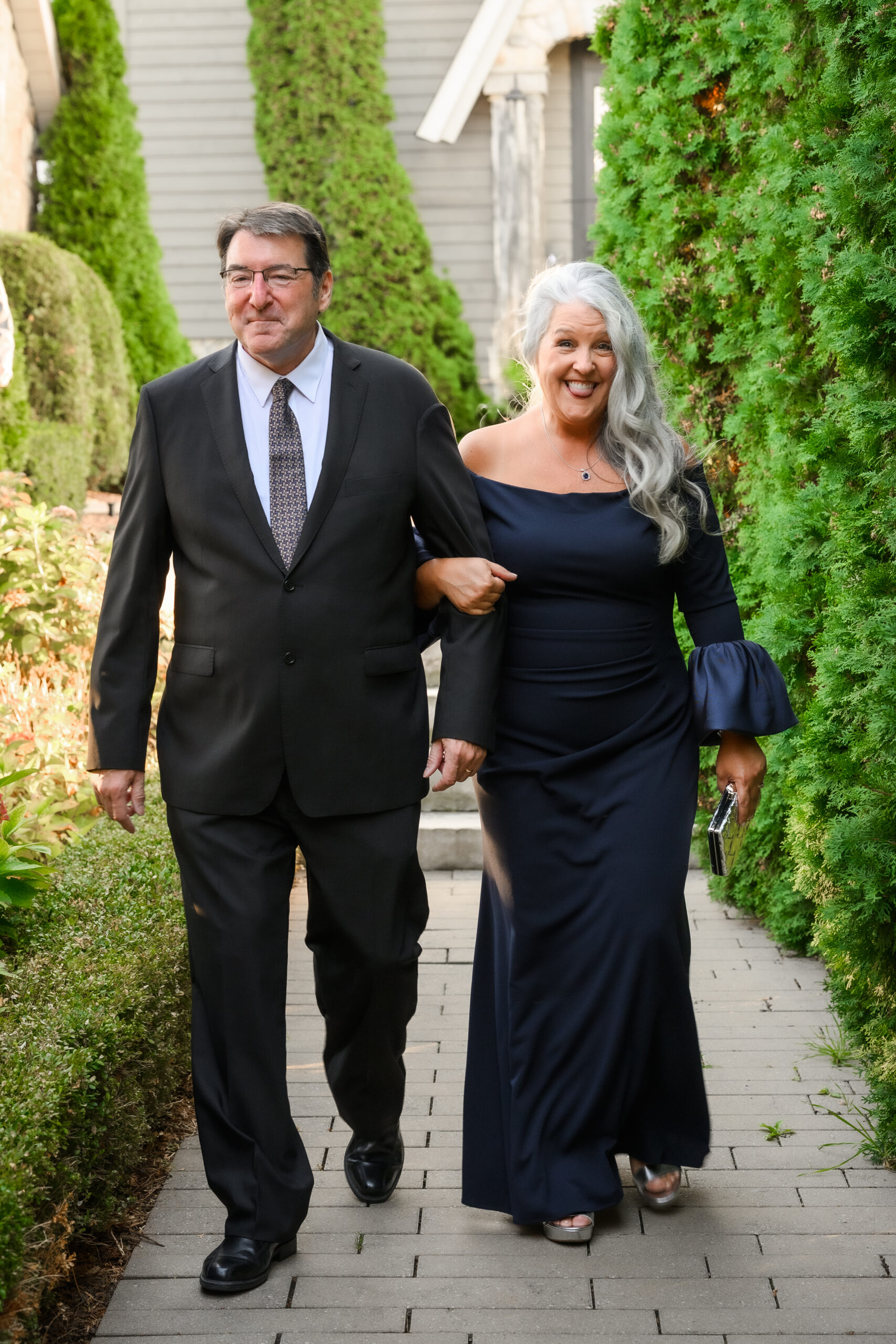 Mother of the groom enters ceremony space with tongue sticking out